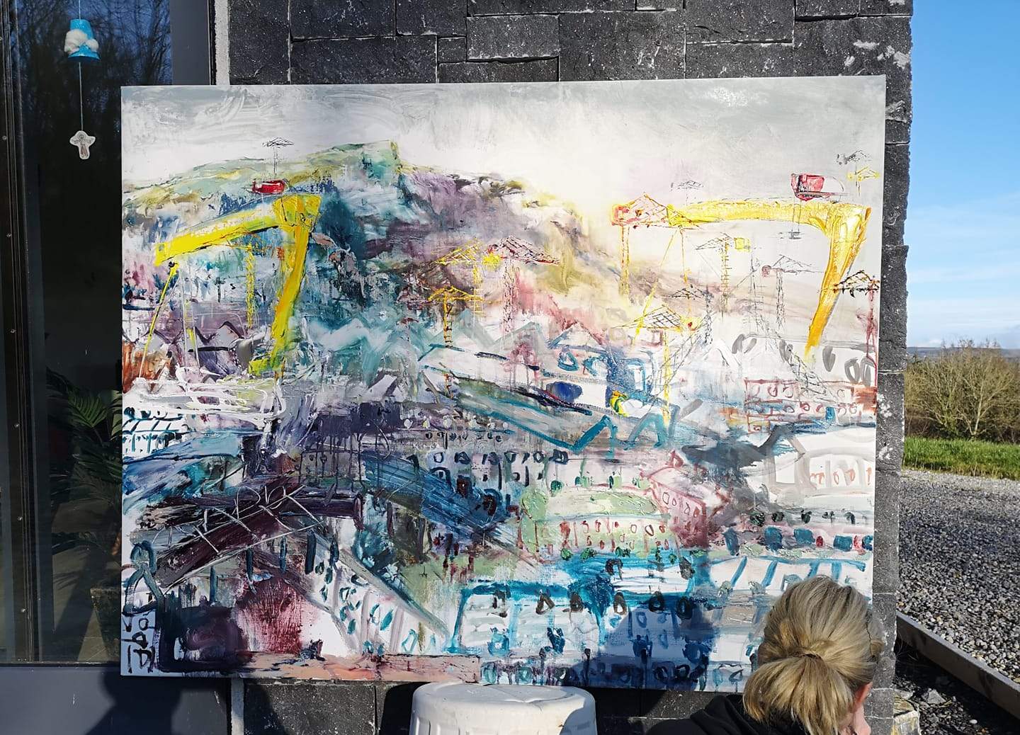 Una O'Grady oil on canvas original painting Streets of the East. A scene of Harland and Wolff cranes in East Belfast. Cave hill features
